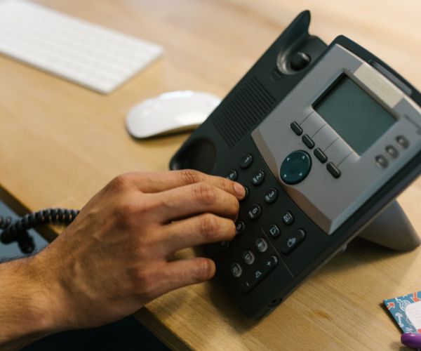 Phone Number Porting - Man using desk phone