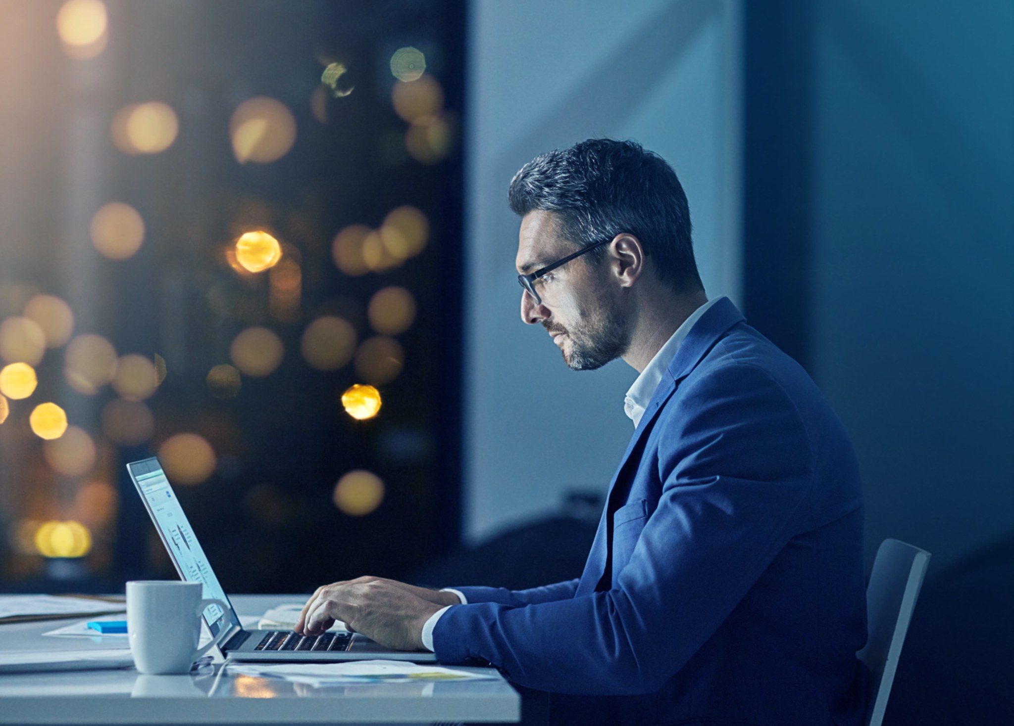 Man Working late at night on laptop