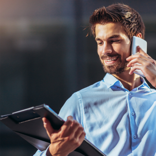 Microsoft Teams Phone - man with a clipboard making a call on a mobile phone