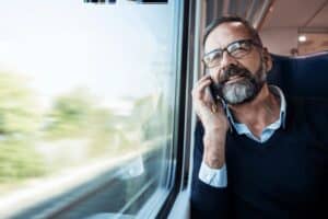 Man on Train on Mobile Phone - Business Mobiles