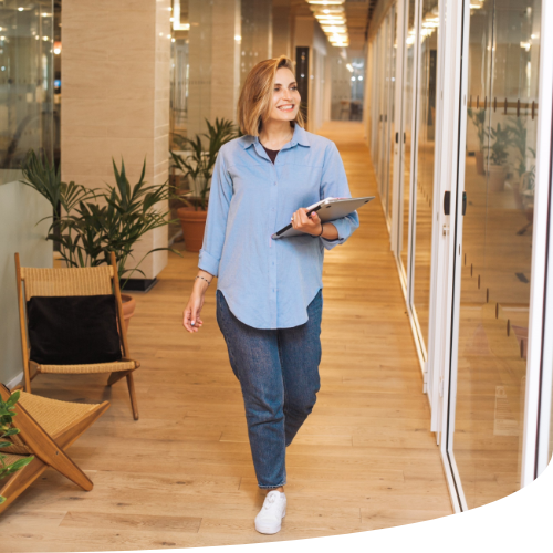 Woman walking through office - Workspaces